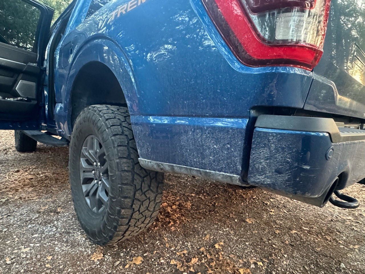 Before detailing: rear quarter panel and bumper of a blue Ford F-150 Tremor